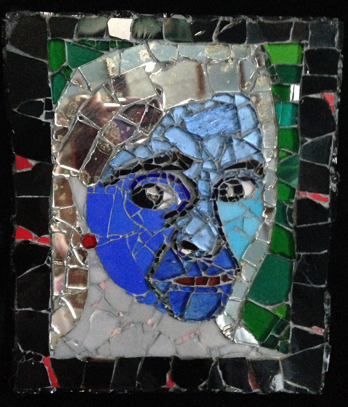 Picture of glass mosaic on wood portrait of Elvira with mirror gray hair and blue face with green background and black border